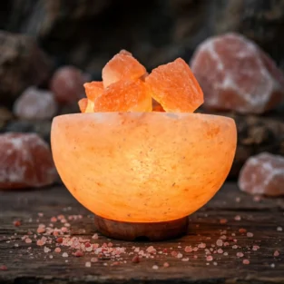 Himalayan fire bowl salt lamp glowing with orange salt chunks on wooden base 1320x1320 product shot