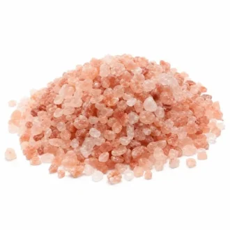 Coarse dark pink Himalayan salt crystals pile isolated on white background